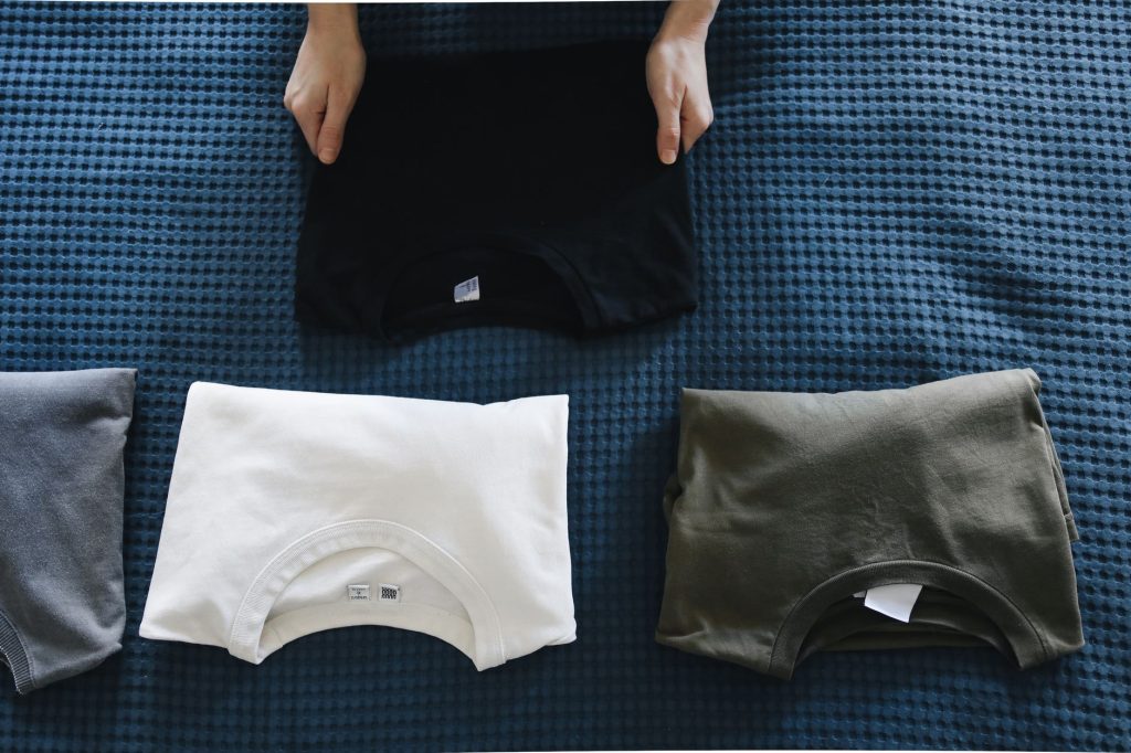 Pliage du linge propre sur un plan de travail dans une buanderie organisée